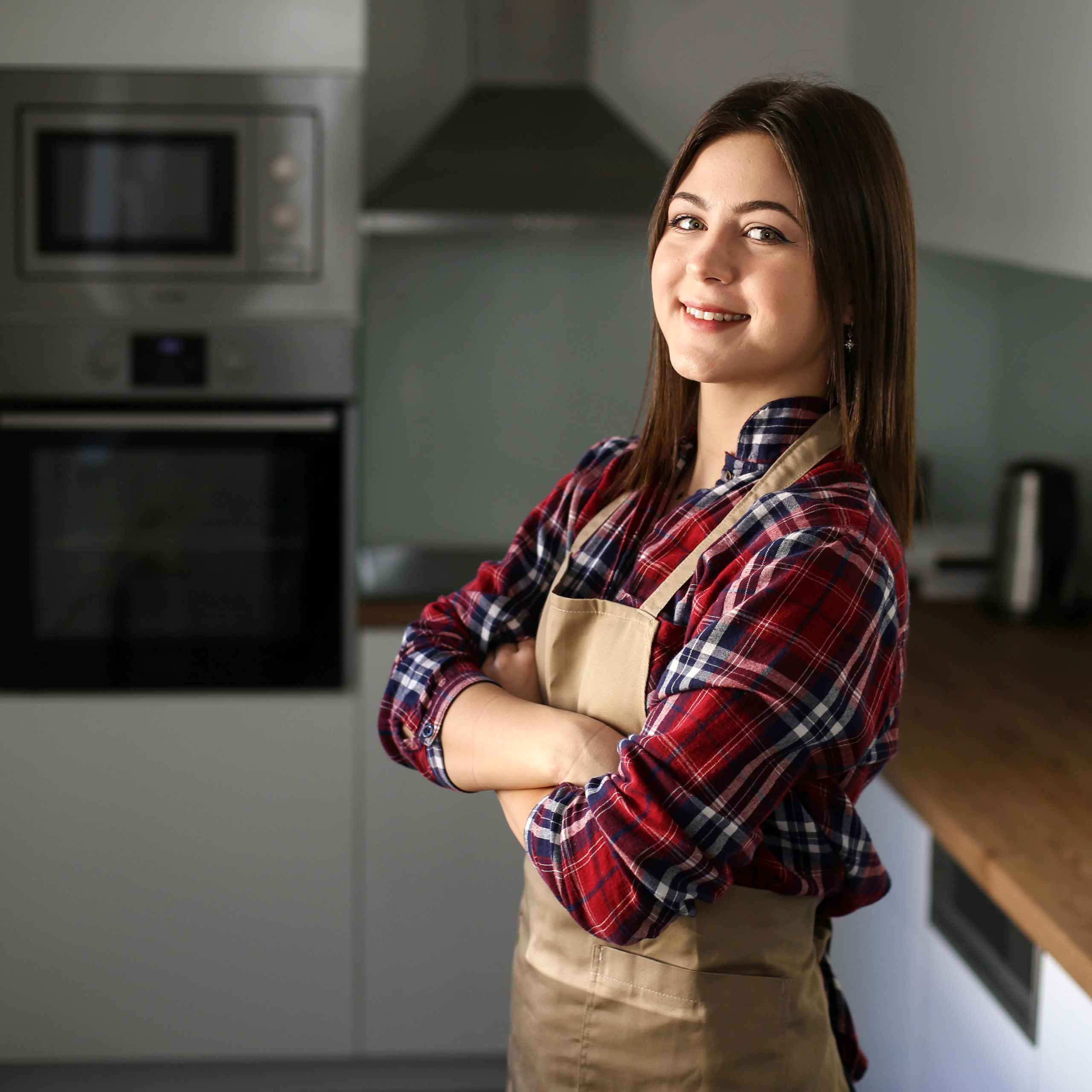 Portrait of a smiling woman in a kitchen
